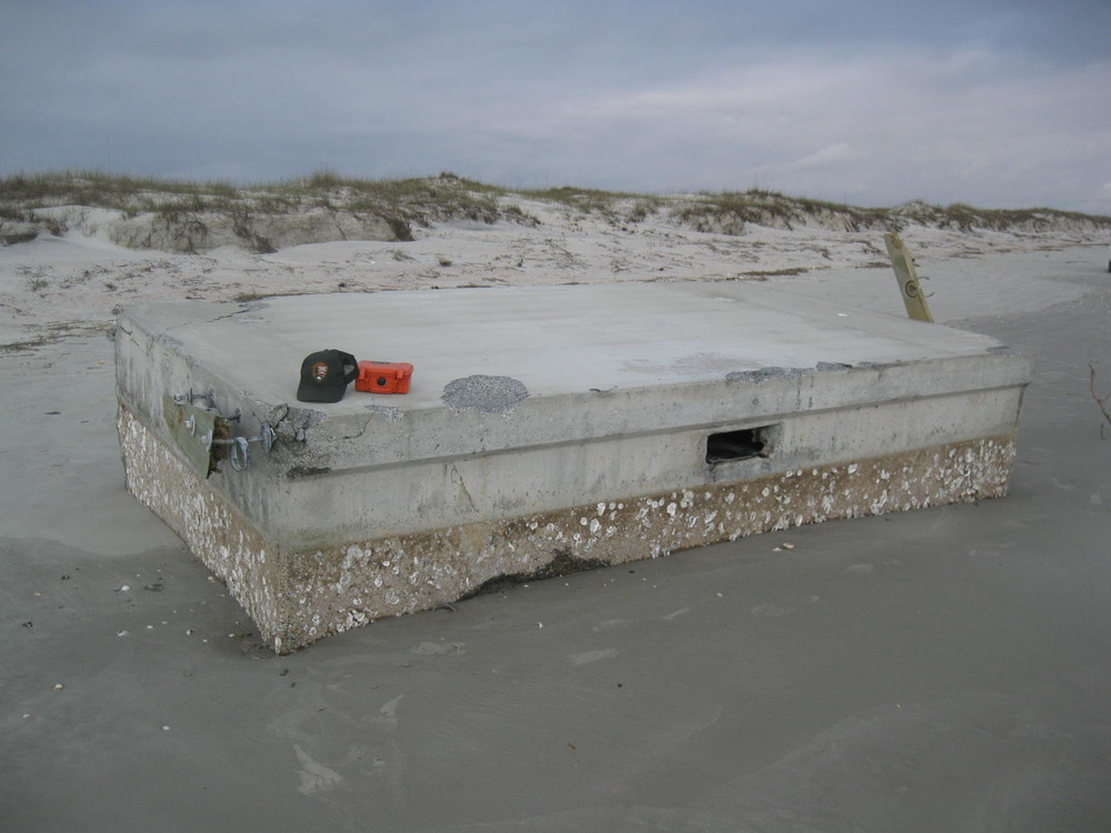 Section of floating dock marooned on ocean beach during Hurricane Irma.