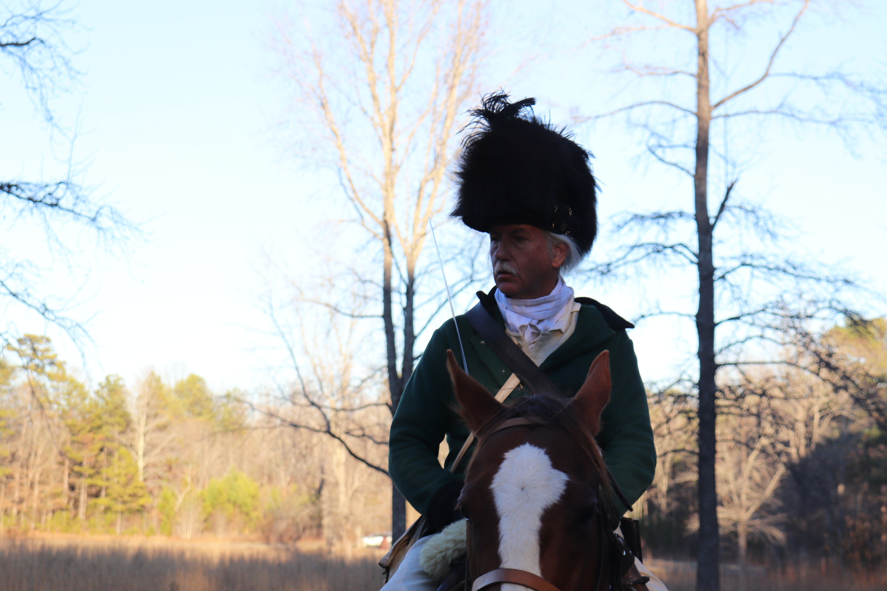 A single living historian dressed as a member of the legion cavalry is mounted and is getting ready for a cavalry demonstration.