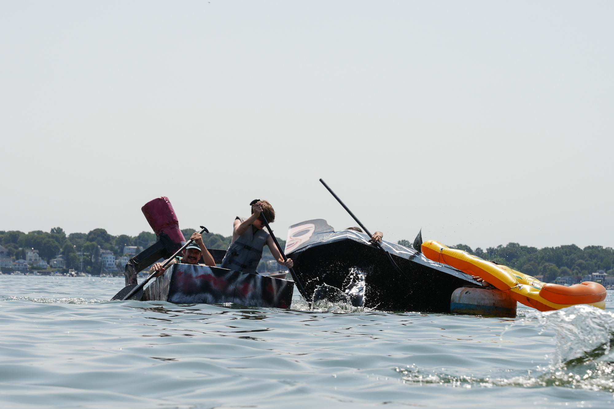 A cardboard boat capsizes in a fun race.