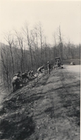 Flattening fill slope using hand labor and motor grader at Station 176