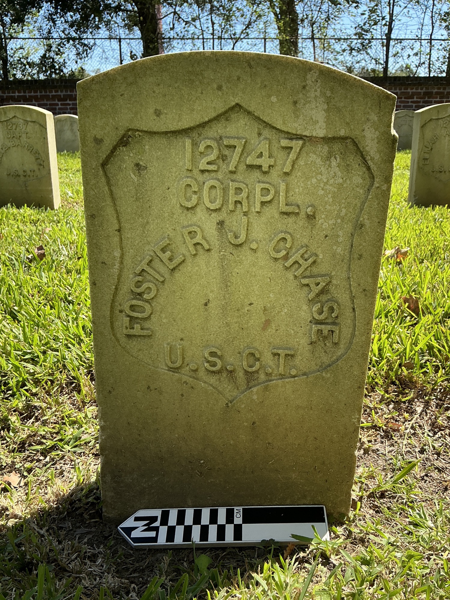 Extra image of historic upright marble headstone with recessed shield face.