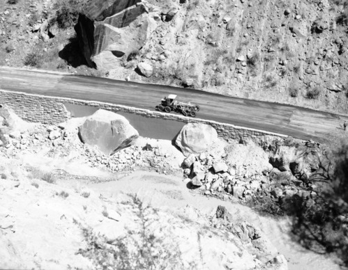 Flood damage repair - Zion Canyon, December 1966 flood. Grader fixing road between Birch Creek and Pine Creek on scenic drive.