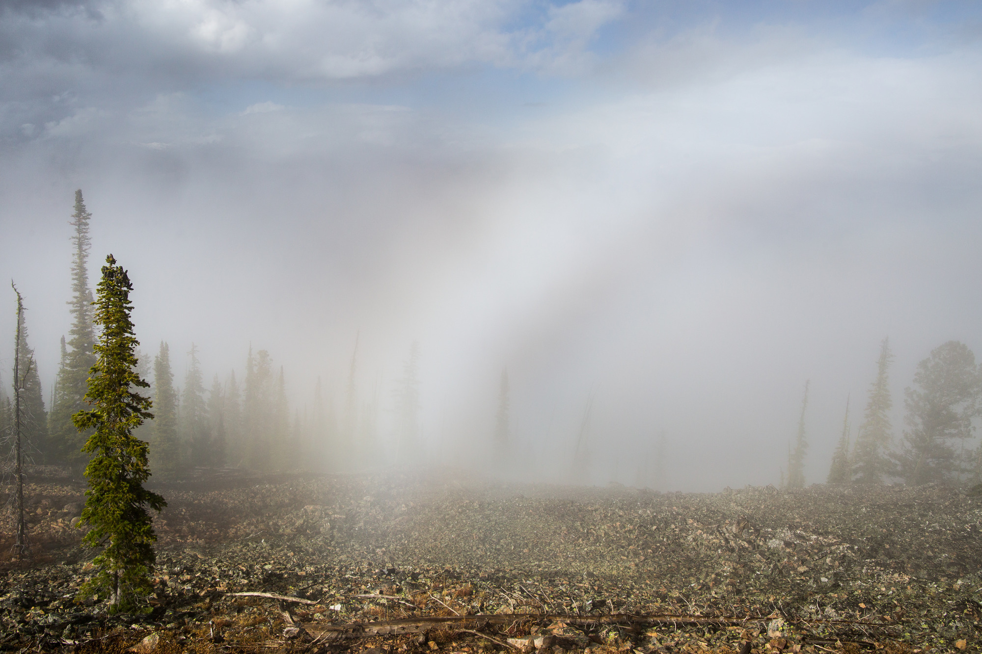End of a fog bow on a rocky hill