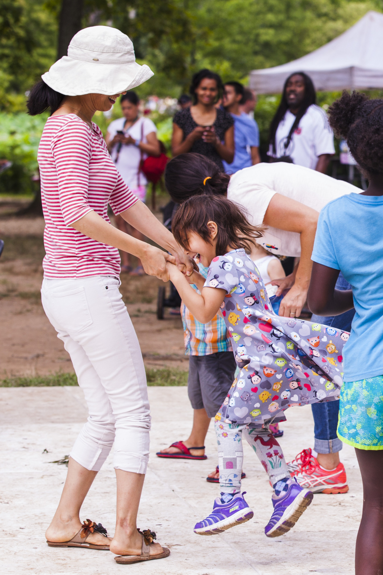 A young girl dances with a woman on the dance floor