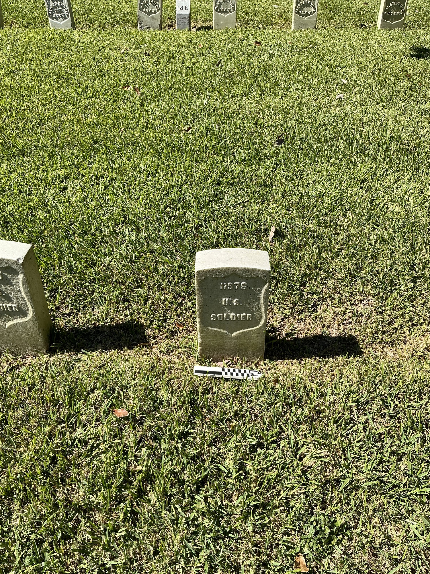 Extra image of historic upright marble headstone with recessed shield face.