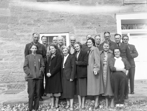 Men and women attendees of the All-Area Staff Meeting pose in front of the ranger dormitory. Meeting held at Zion National Park on December 5, 1952.