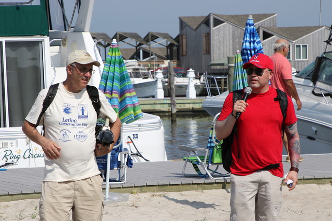 Two people with mics talking at a marina
