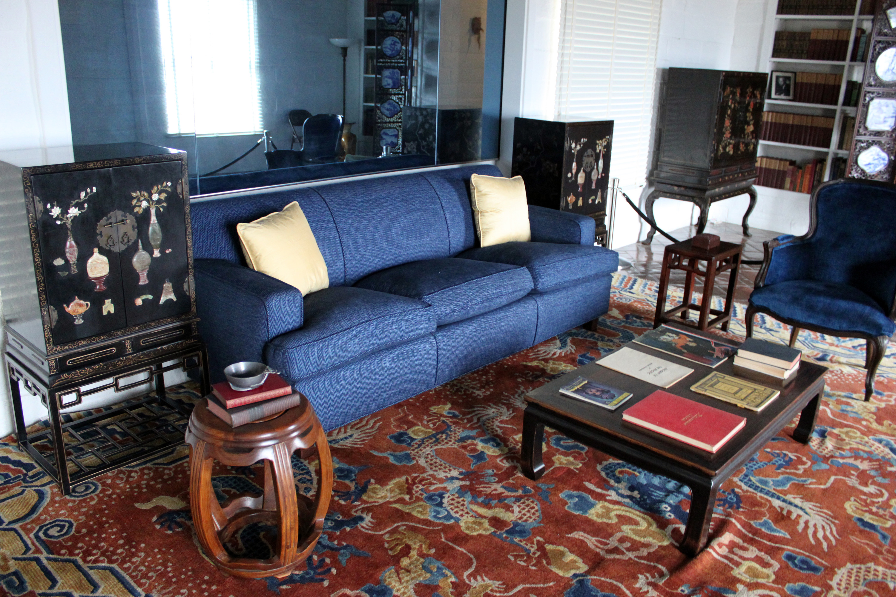 A reproduction couch and various furniture pieces sit in the Eugene O'Neill Tao House living room. 