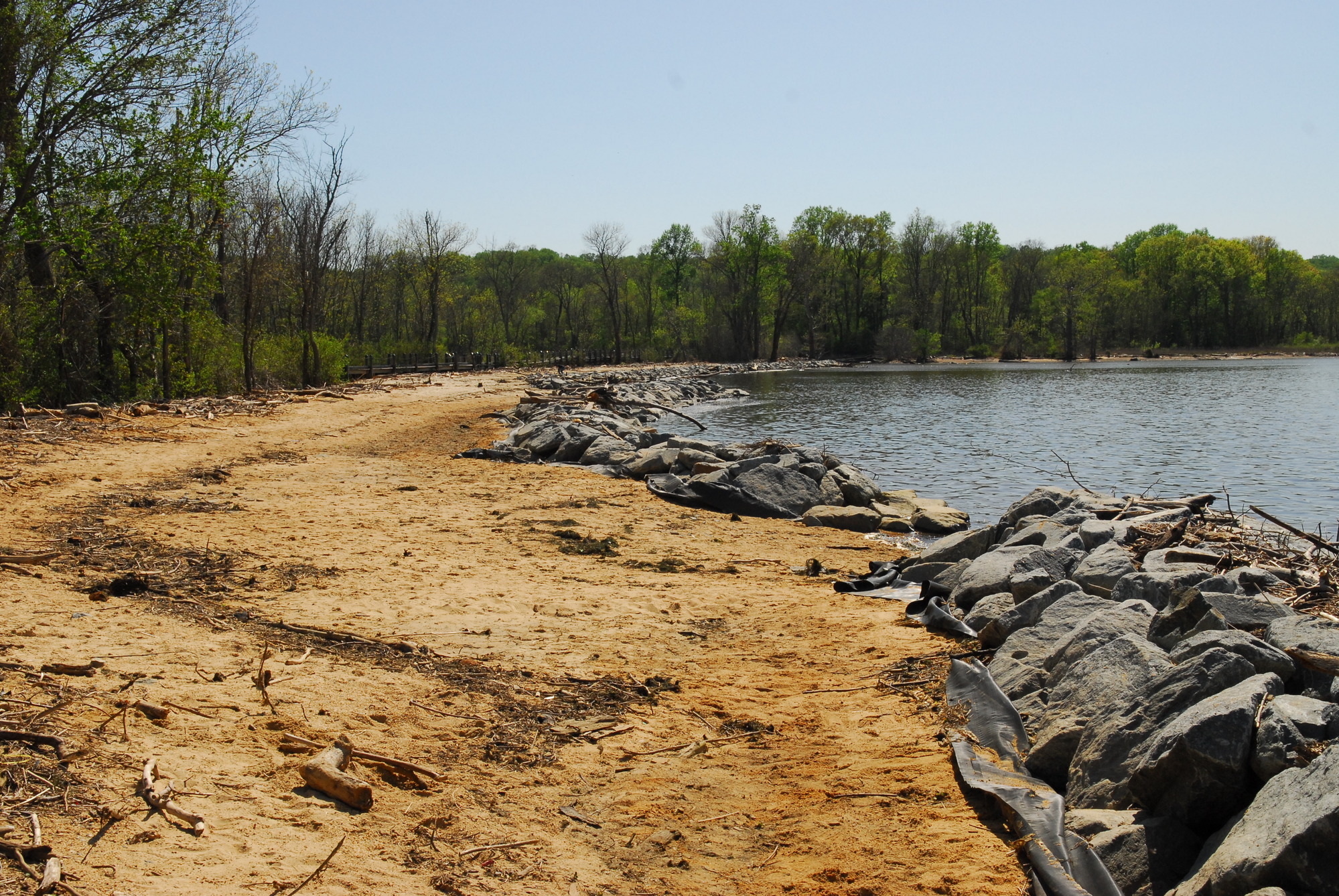A sandy beach with rocks next to the Potomac river