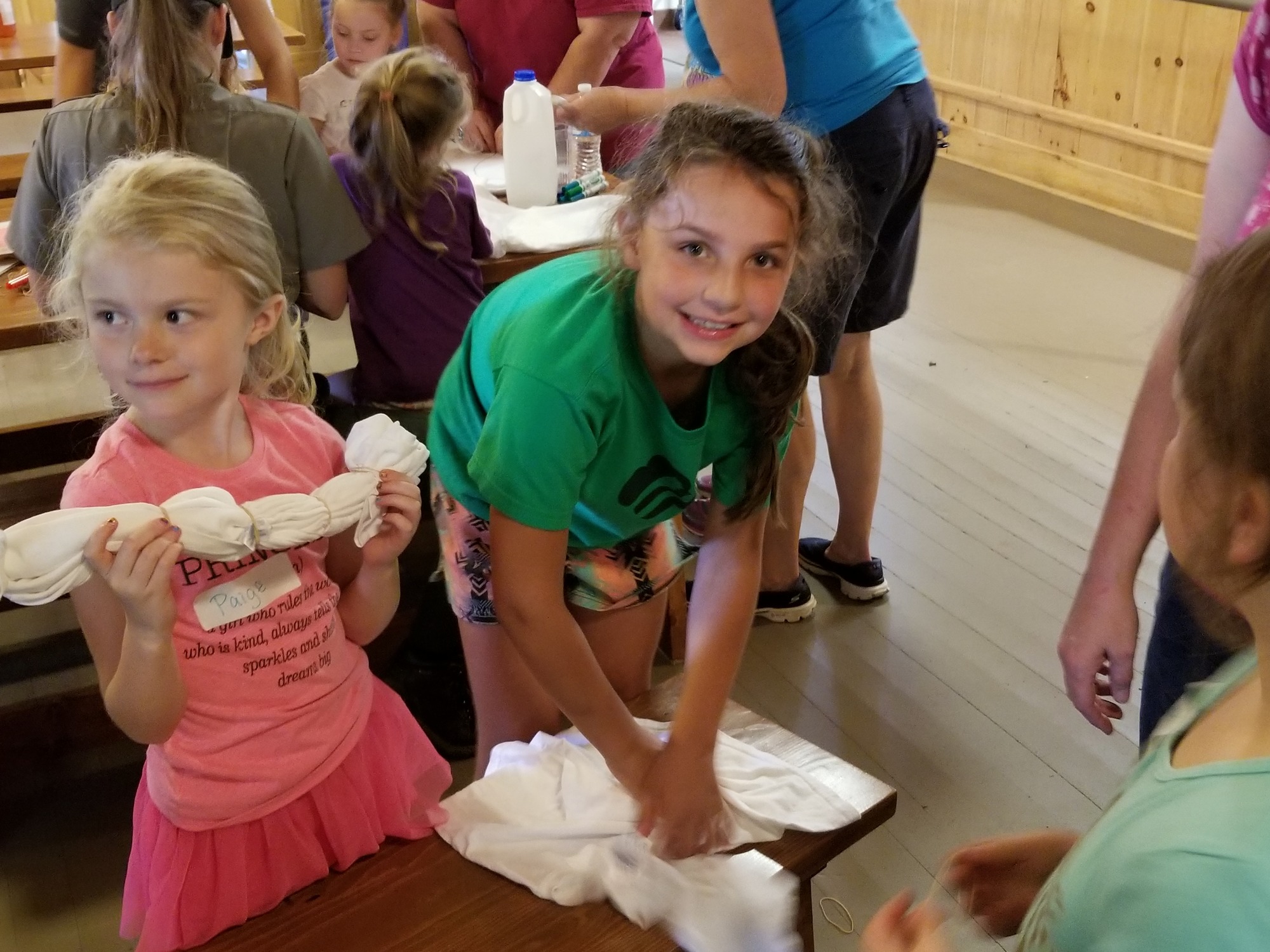 girls in a cabin rolling tee shirts