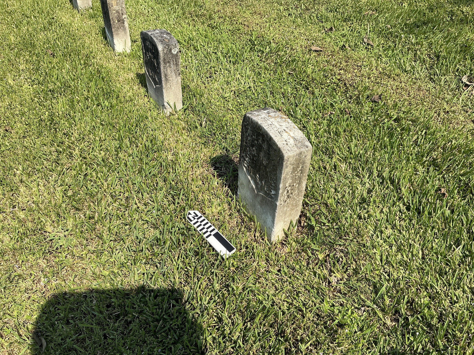 Extra image of historic upright marble headstone with recessed shield with recessed lettering face.