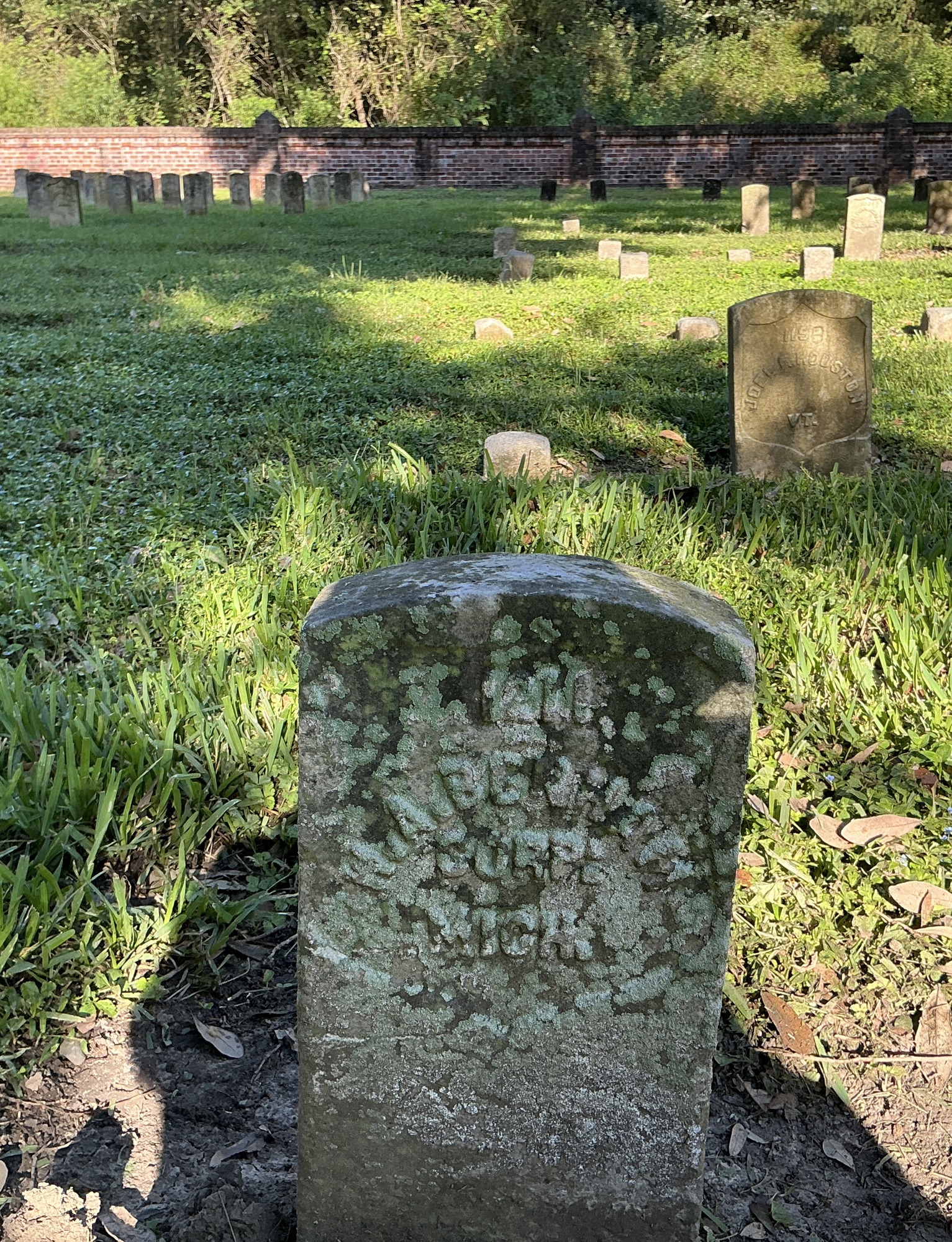 Extra image of historic upright marble headstone with recessed shield with recessed lettering face.