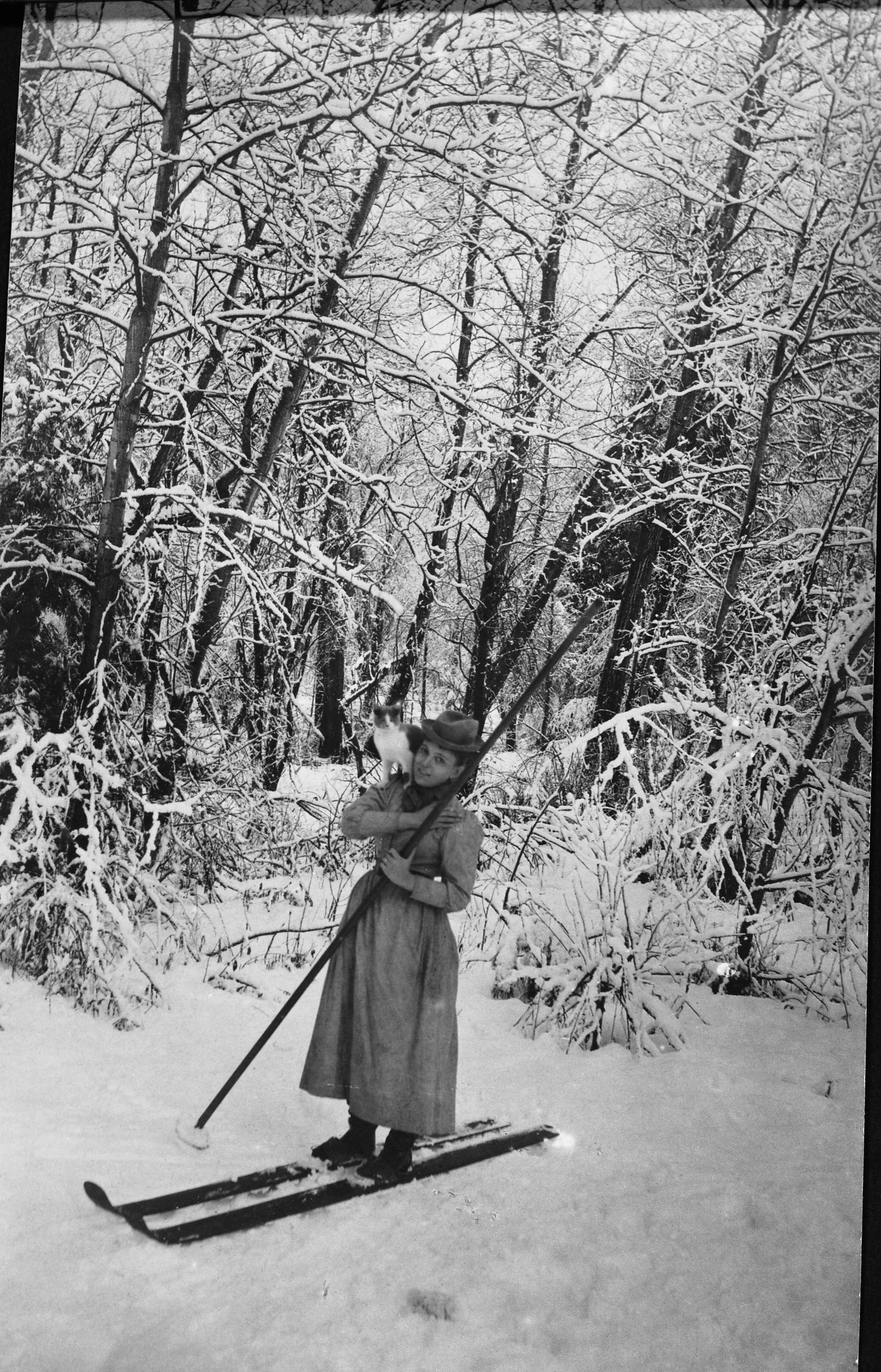 Copy Neg: Leroy Radanovich, September 1998. Nellie Atkinson, on Norwegian snowshoes with cat on her shoulders. Title "Maxie's Snow Shoe Ride". Also YOSE 5260 and YOSE 18191.