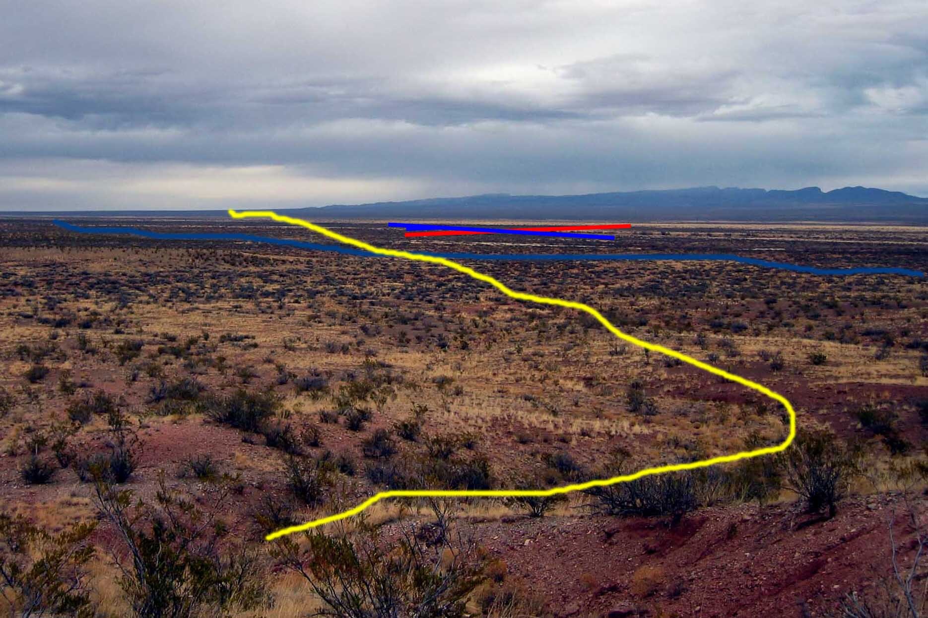 A yellow arrow is pointing to a line in the desert.