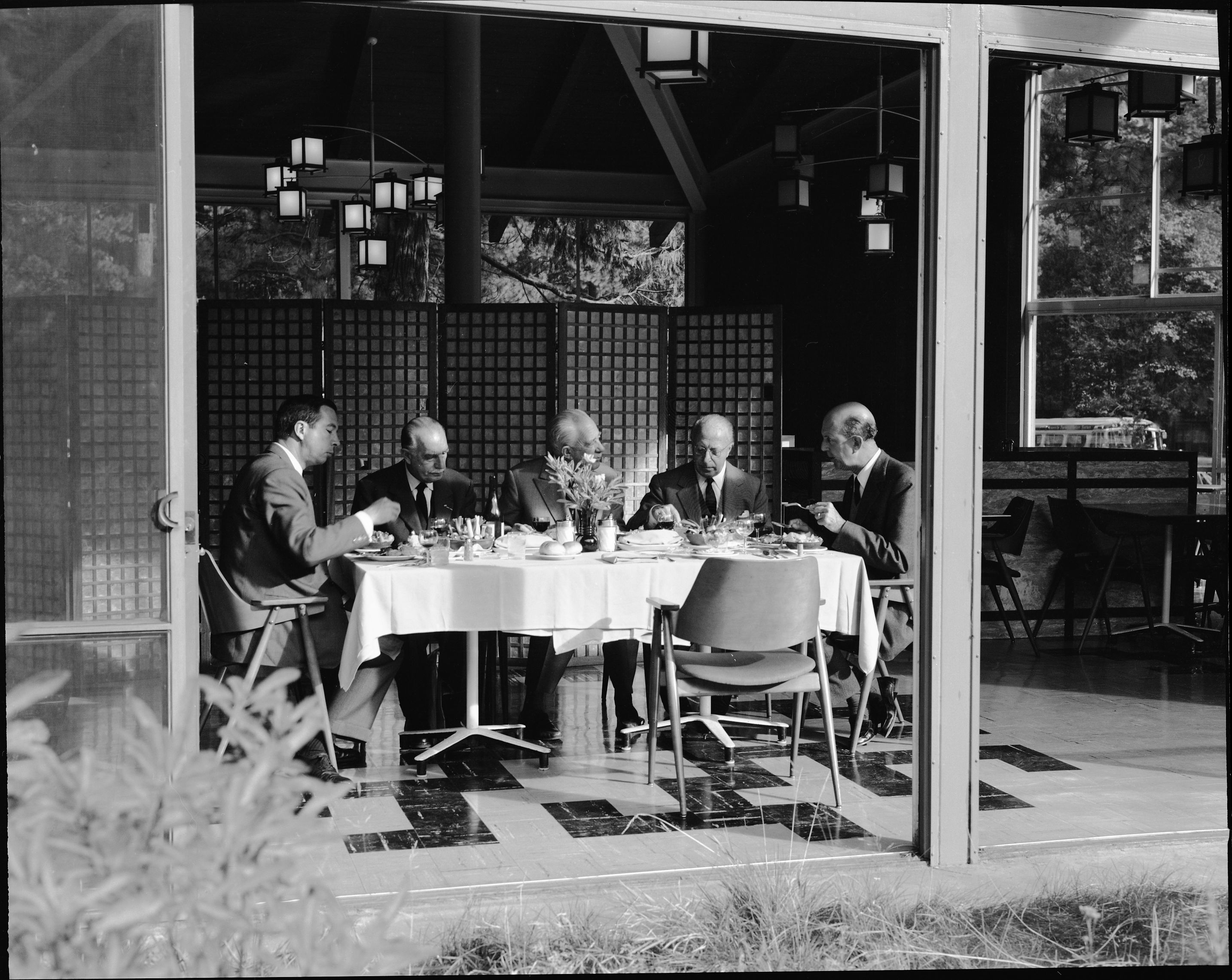 King Umberto & Party of Italy, in the Village Restaurant. Looking at the side of the dining table: Left to right: Mr. Wm. N.L. Hutchinson, Jr.; Count Raimondo Olivieri; the Duke of Morignano, Don Eugenio Ruspoli; Marchese Falcone Lucifero; and His Majesty King Umberto di Savoia.