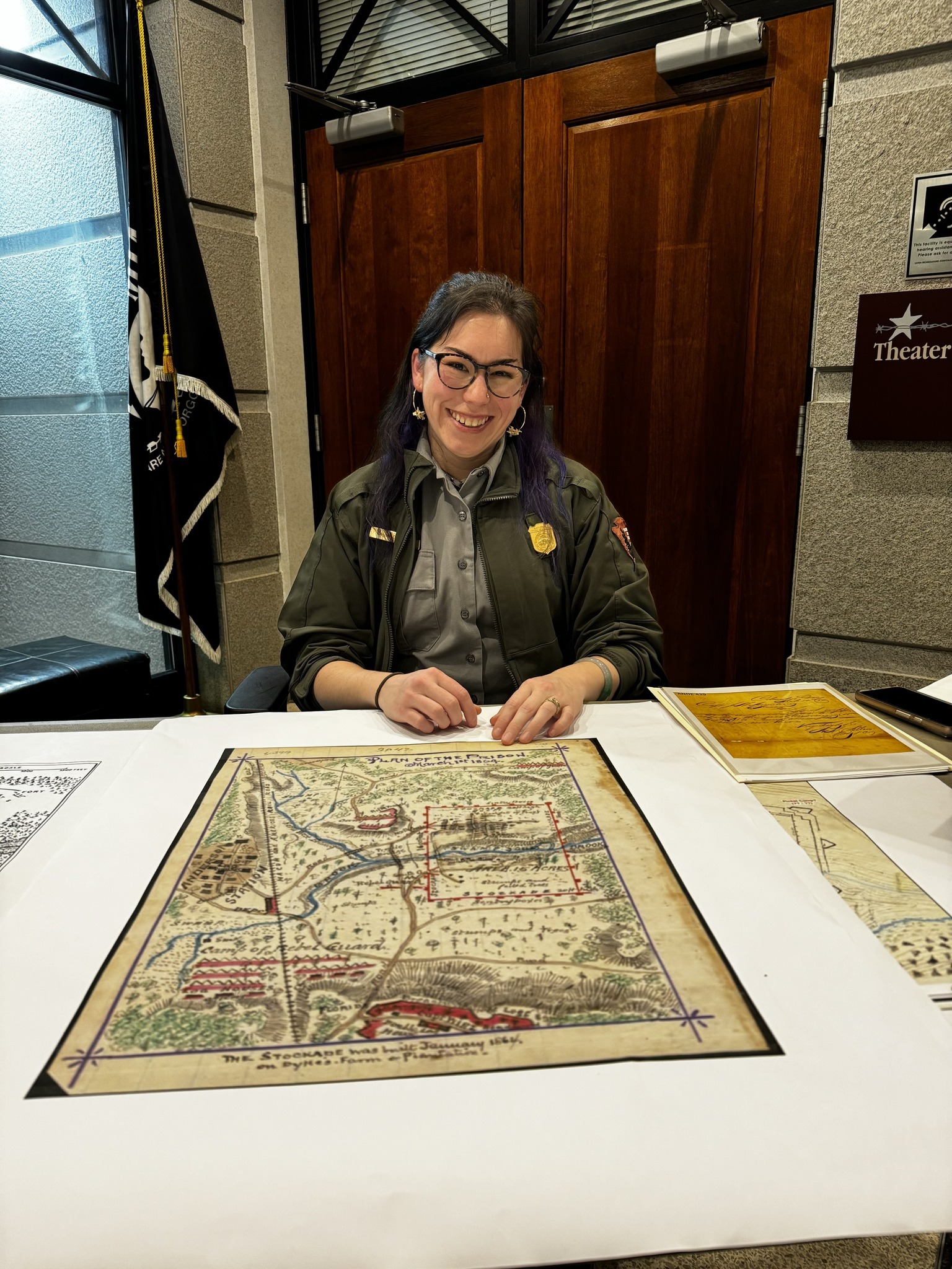 Museum Technician at the historic maps table inside the National Prisoner of War Museum.
