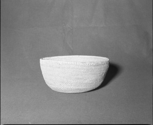 Mrs. Donald Segerstrom Collection. Object: Paiute/Washoe (?). Dimensions: 13 x 6". Materials: Entirely willow. Technology: Base in non-interlocking stitch changing to interlocking stitch for body of basket, fag ends flipped to left and caught with successive stitches, moving ends trimmed on interior for most part. Photographed by Michael Dixon. Catalogued by Craig Bates and Barbara Beroza. Yosemite Collections, National Park Service. 1/83.