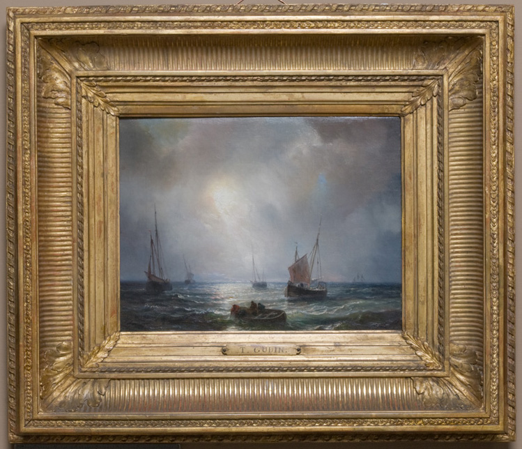 Oil painting in gold frame of ocean with four sailboats and a rowboat, sun shining through clouds
