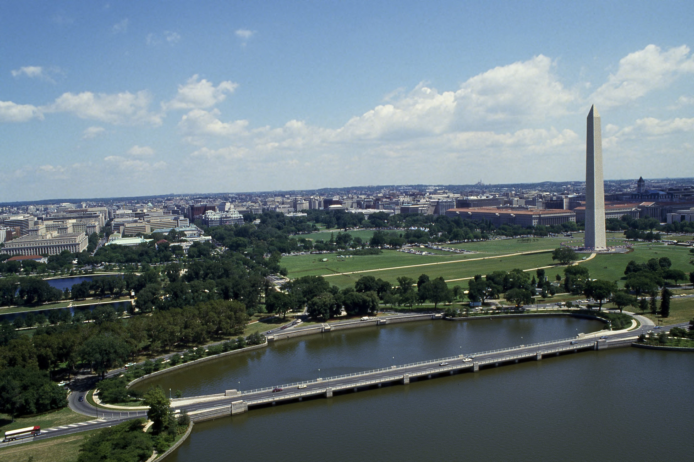Aerial view of Kutz Bridge crossing over the water with the Washington Monument behind.