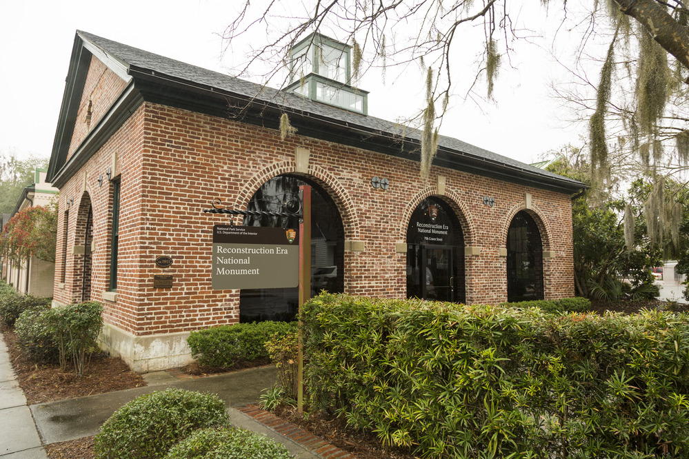 Brick building with a National Park Service sign in front of it. 