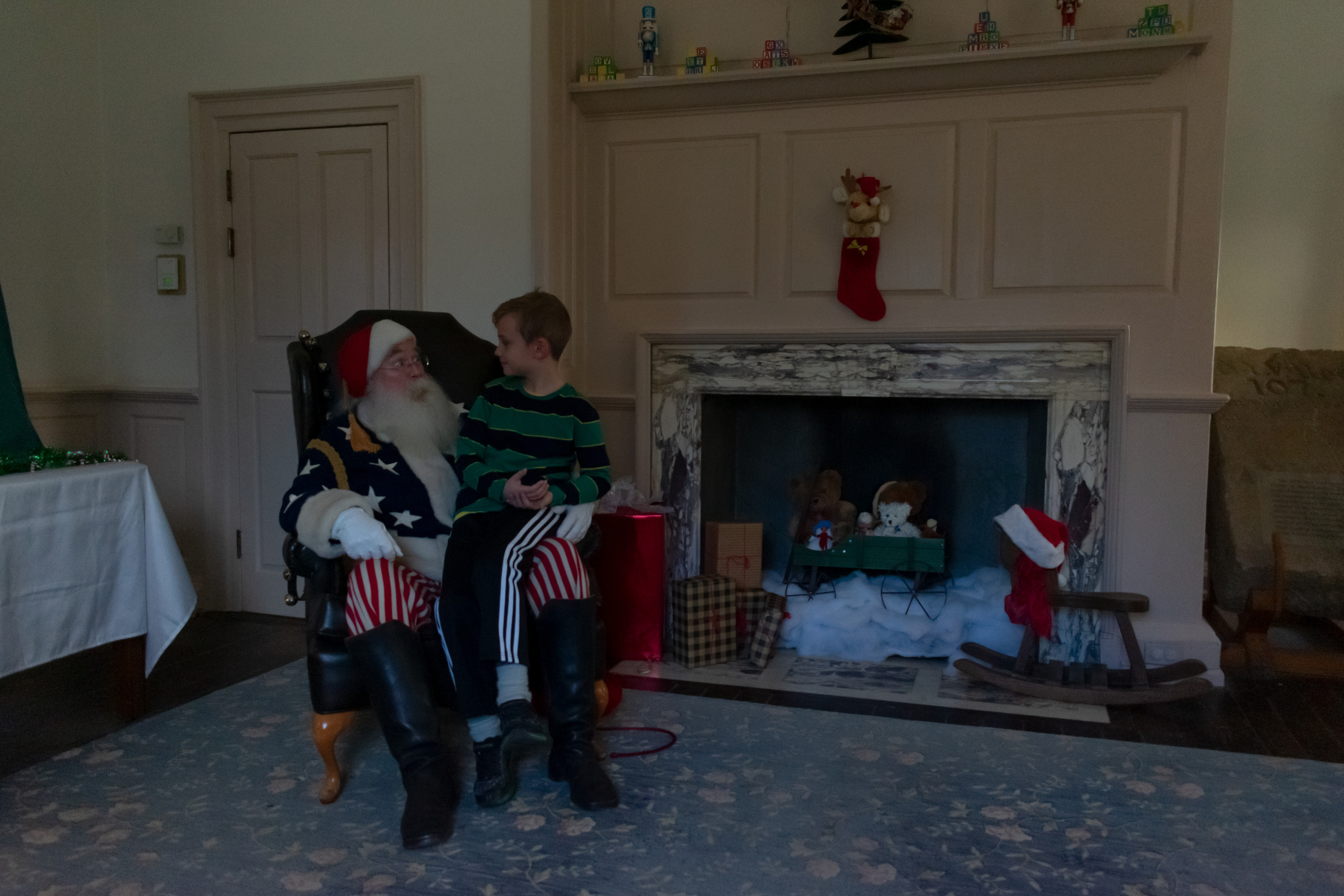 A boy sits on Santa's lap.