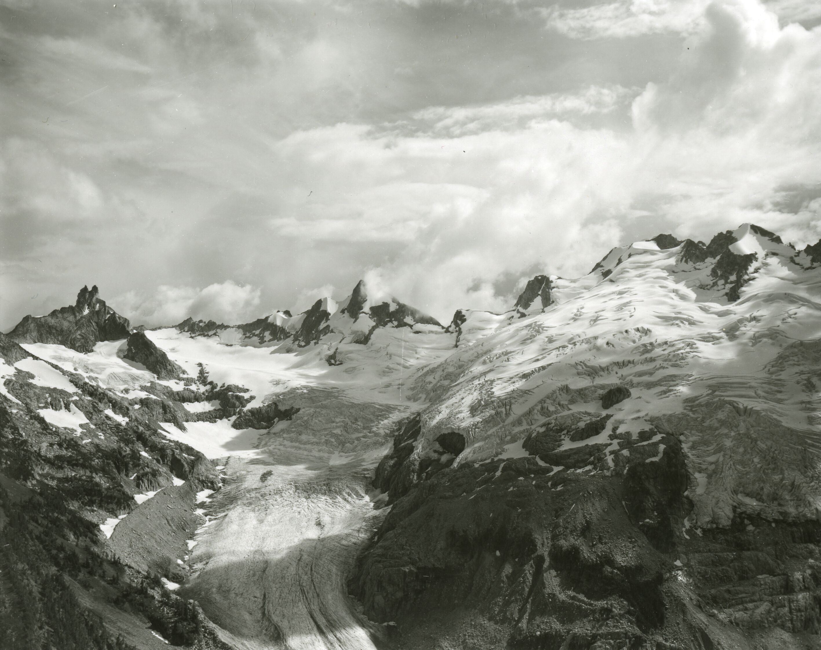 A glacier cascading down the side of a mountain.