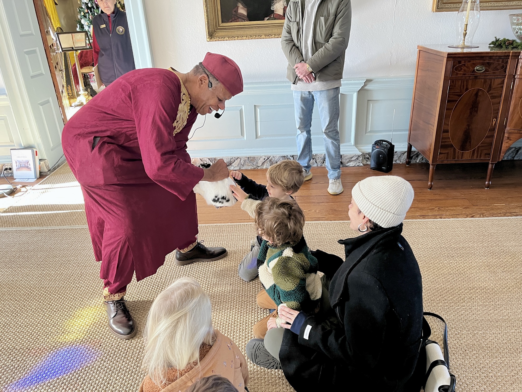 Children petting rabbit during the Griots' Circle of Maryland storytelling sessions