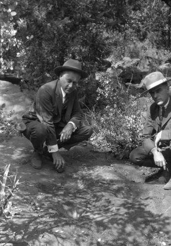 Stephen T. Mather & Supt. W.B. Lewis at an old Indian mortar rock near Govt. Center.