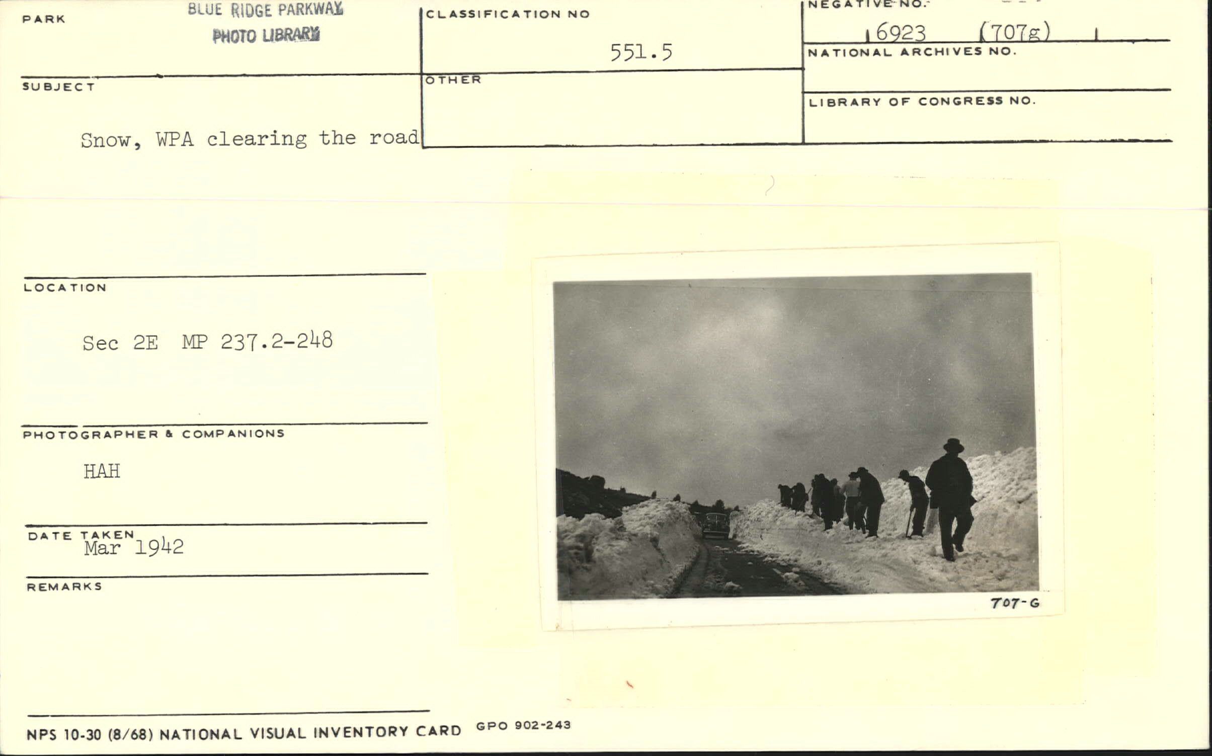 Snow with WPA workers clearing the road