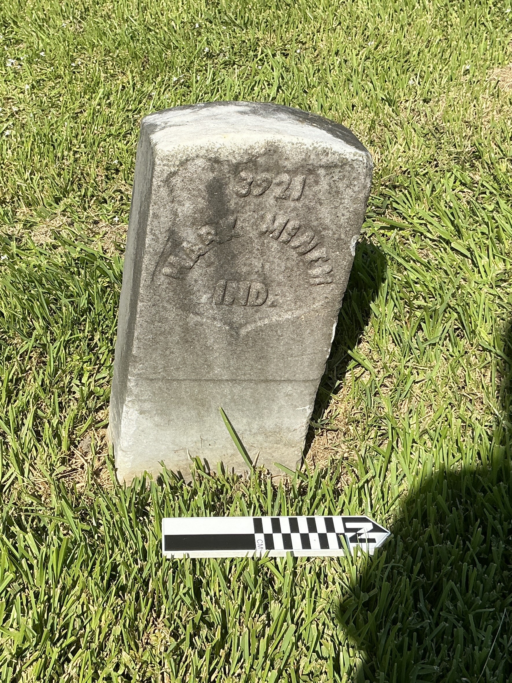 Extra image of historic upright marble headstone with recessed shield with recessed lettering face.