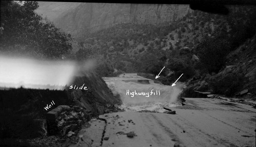 Flood damage on park road route 1.' May 14, 1941 landslide and flood damage in Zion Canyon about one and a half miles up the canyon from park headquarters. Landslide caused river to undercut and remove a portion of the park road. [Safety film copy of an original nitrate negative. See catalog numbers ZION 13263, ZION 13265, and ZION 13266 for related images.]