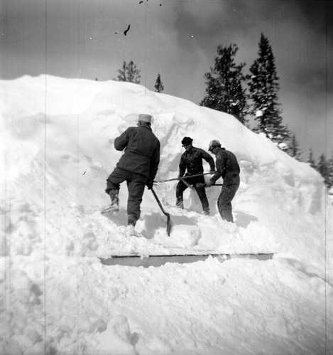 BW Photos showing rangers digging out the visitor center from snowdrift.