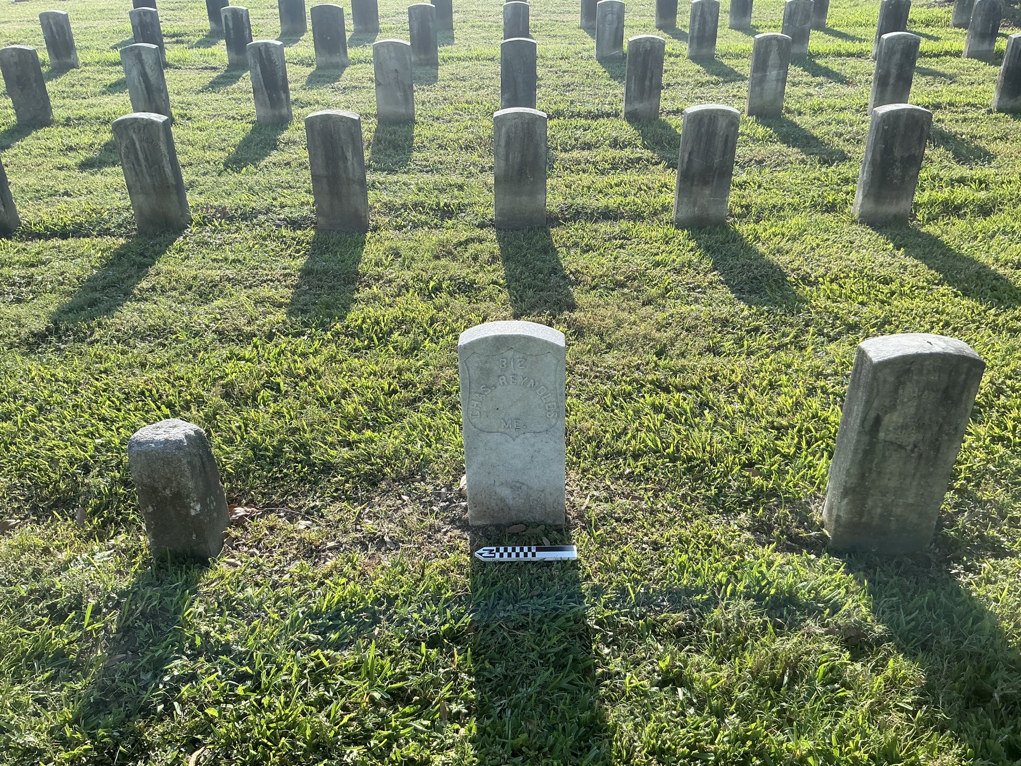 Extra image of historic upright marble headstone with recessed shield face.