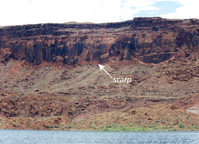 Photograph of landslide scarp along the east shore of Good Hope Bay, Glen Canyon National Recreation Area. The scarp appears as a “fresh” surface above the talus slope.