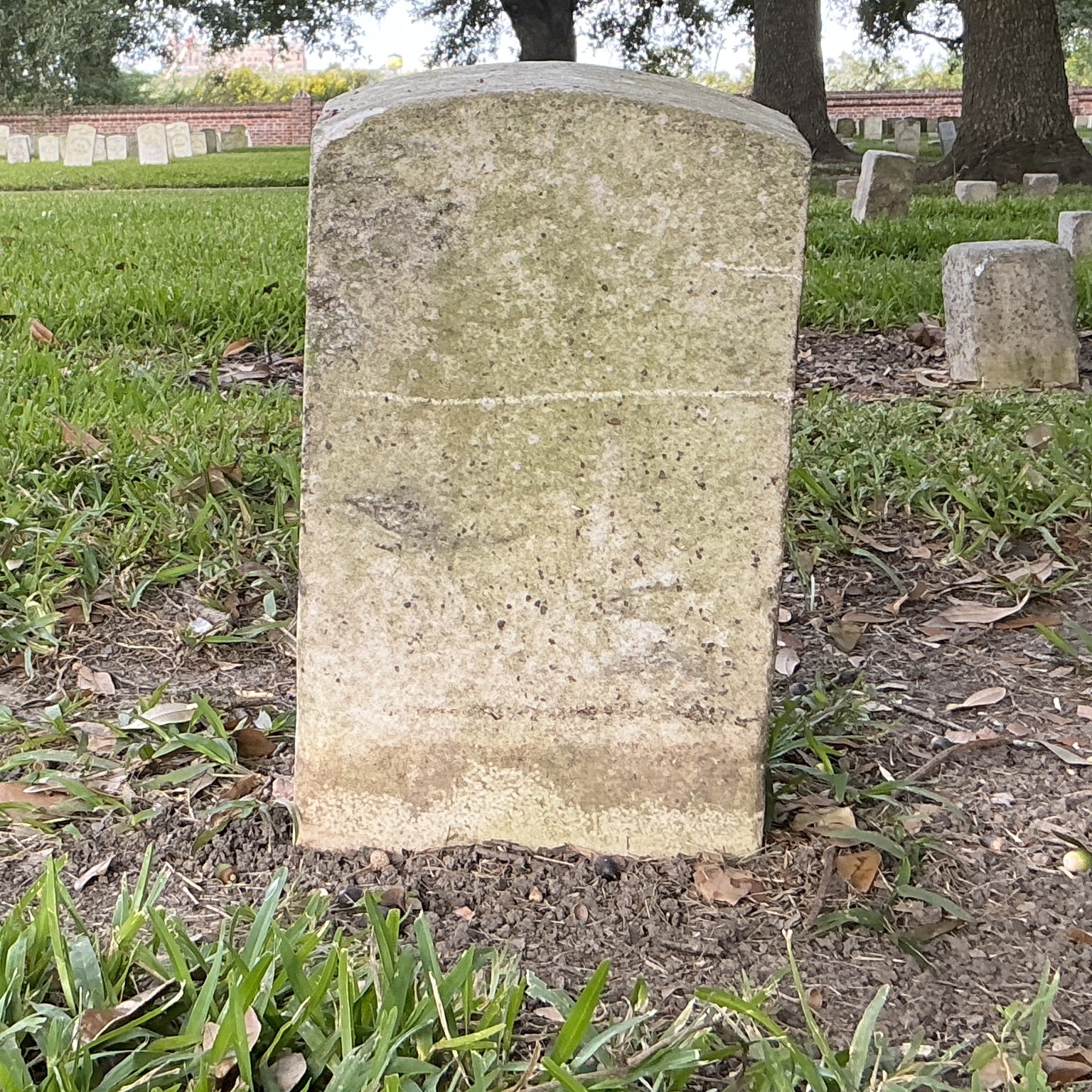 Back of historic upright marble headstone