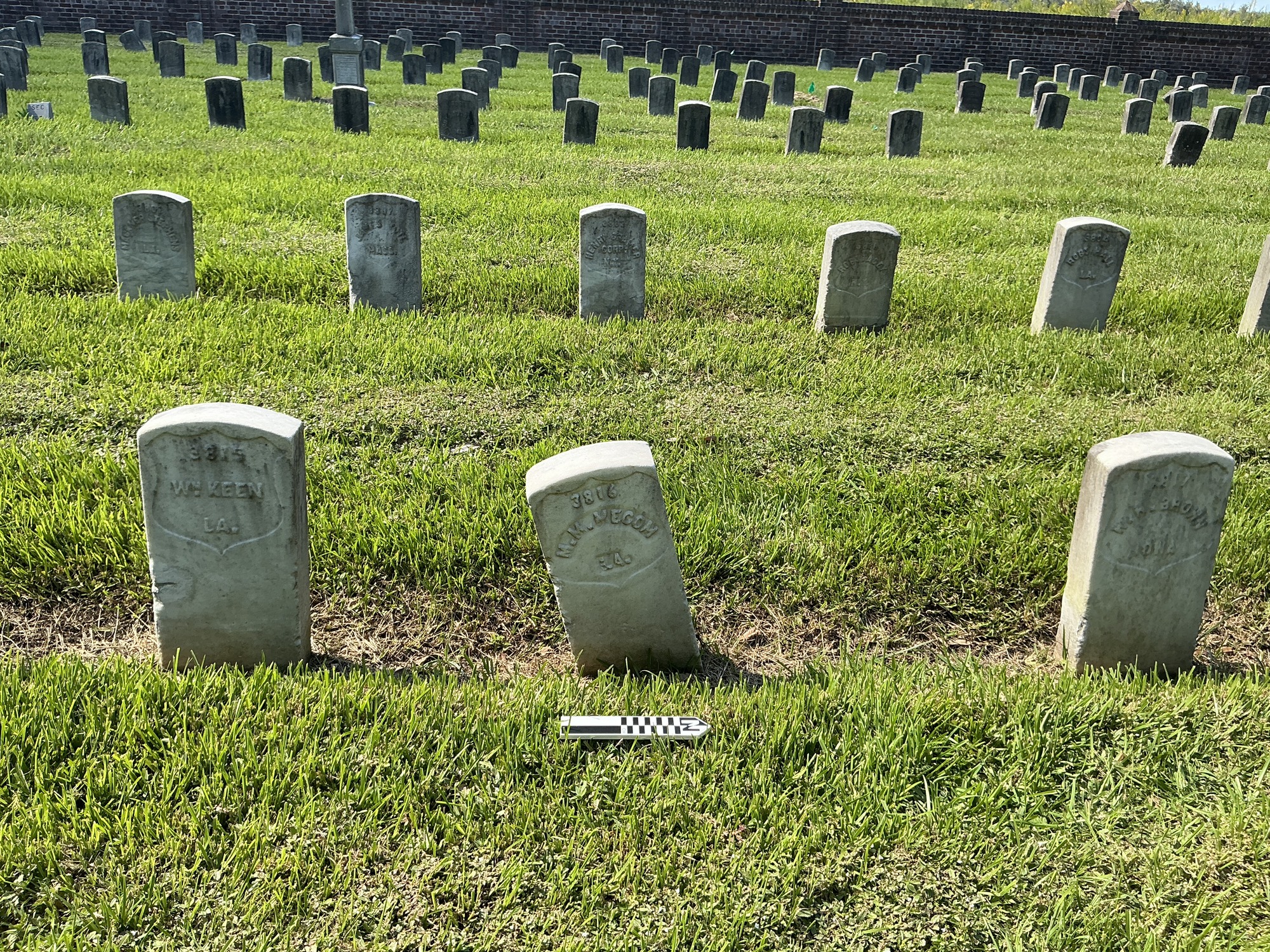 Extra image of historic upright marble headstone with recessed shield with recessed lettering face.