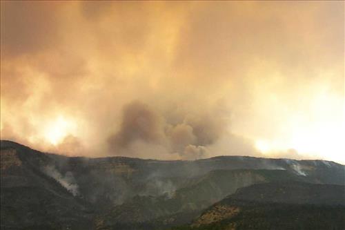Intense burning with heavy gray and black smoke and flames during the Bircher fire, Mesa Verde National Park, July 2000