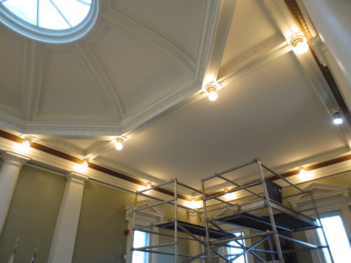 Ceiling of Bunker Hill Lodge with decorative molding and lighting feature that outlines the ceiling and molding that goes down the center of the ceiling. 