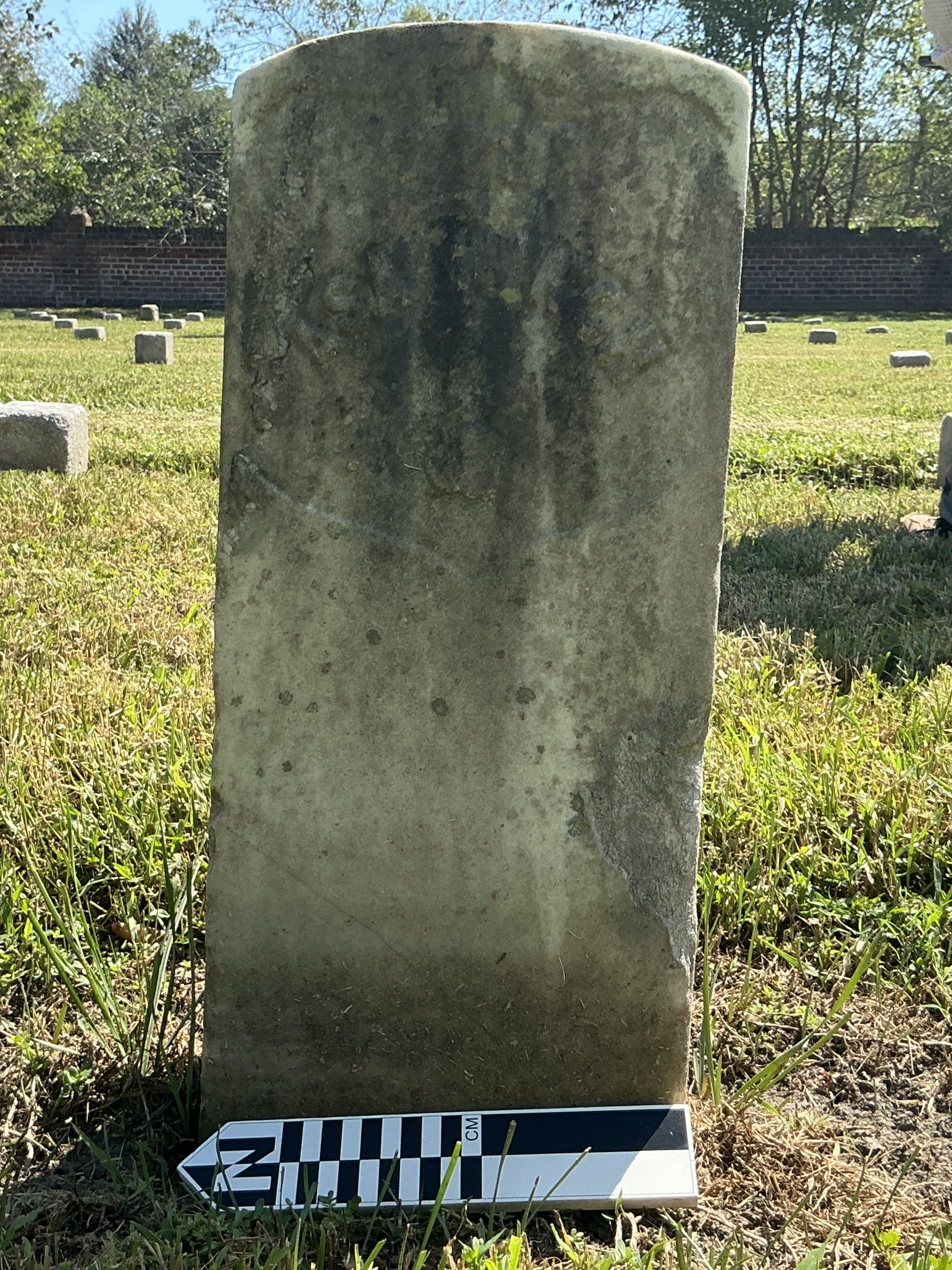 Extra image of historic upright marble headstone with recessed shield with recessed lettering face.