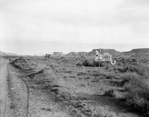 The Grandma's signs on State Route 15 (now State Route 9), black on yellow signs at almost every turn from Virgin, Utah to Zion National Park and the Mohawk Motel sign. Photo was taken on the flats west of Virgin and looking north toward the park for proposed clean up of the undesirable signs and debris along the route to Zion National Park.