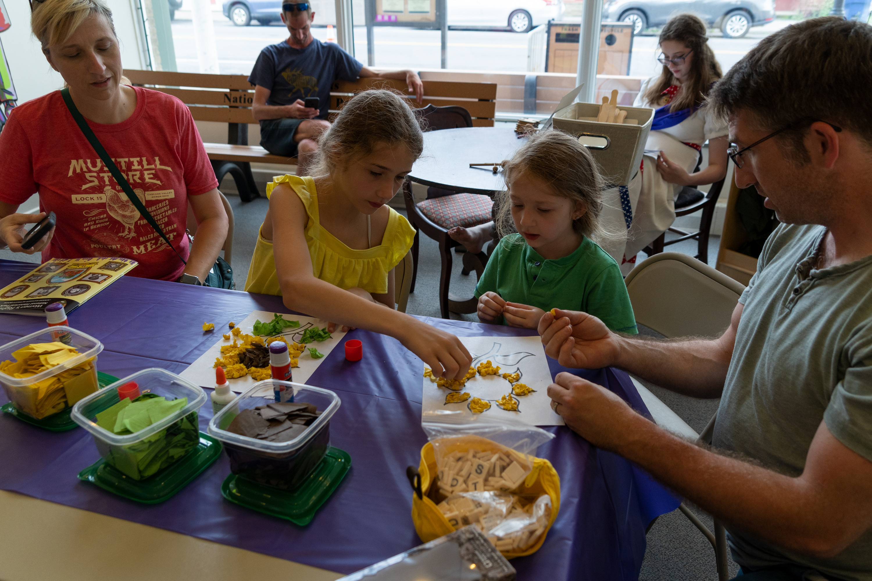 A family making paper sunflowers.