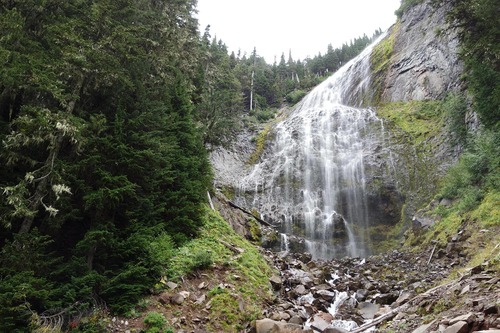 A large waterfall fans out over a cliff. 