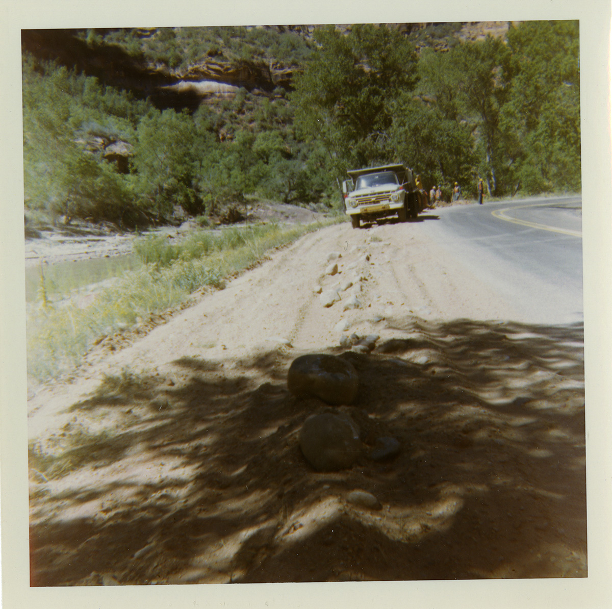 Truck performing shoulder work along route 2 parking areas.