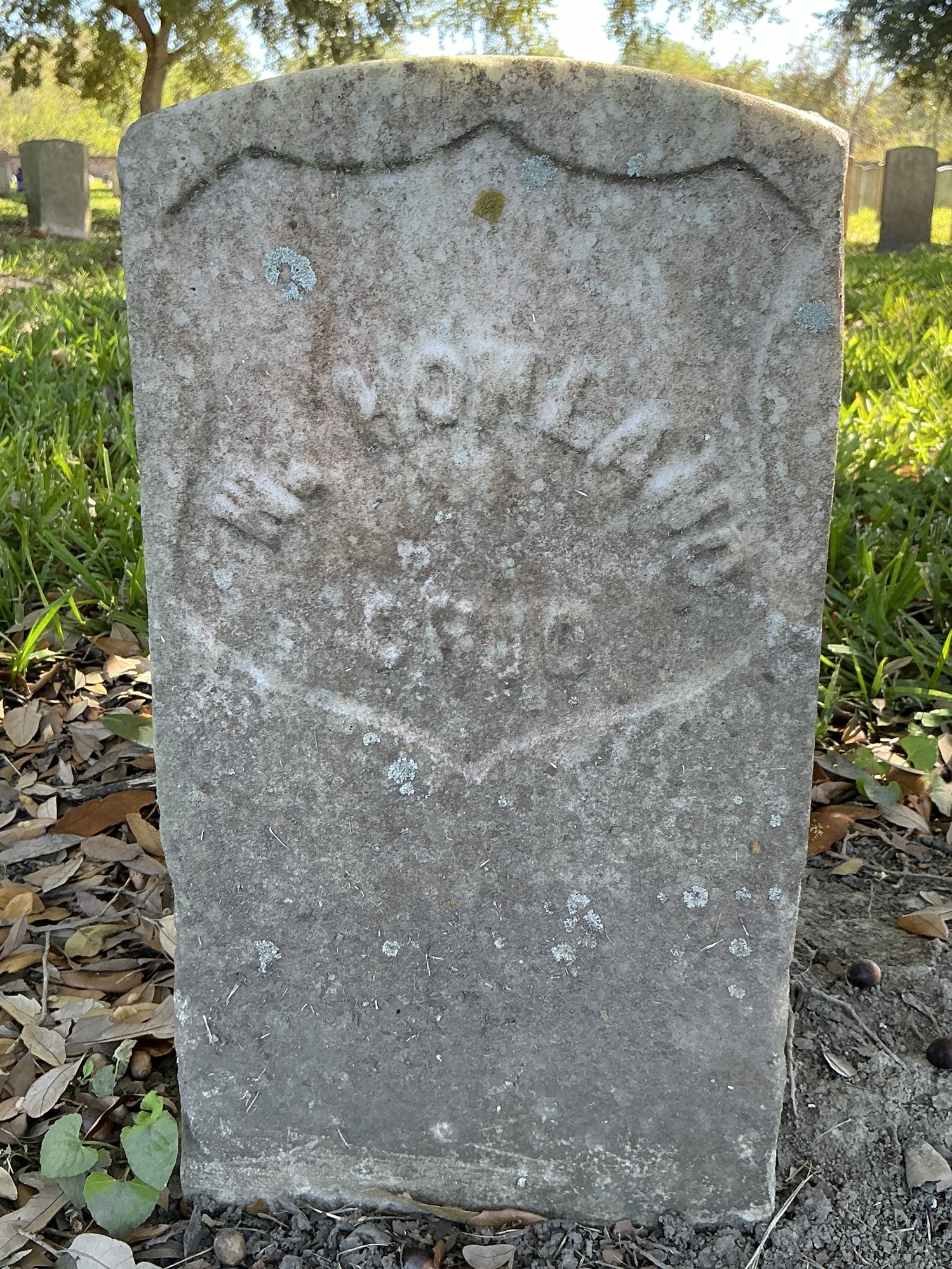 Back of historic upright marble headstone with recessed shield face.