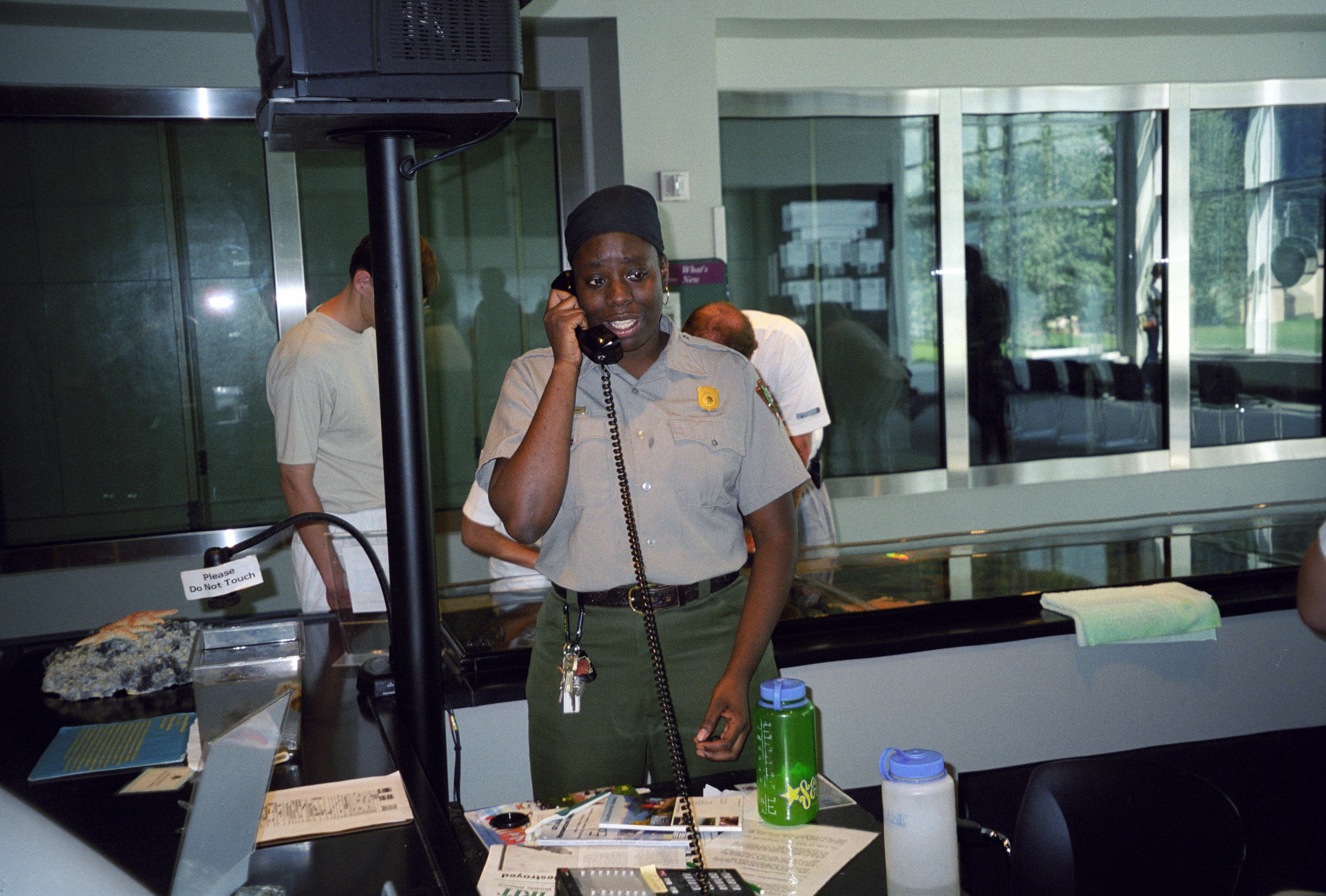 Lena Williams, visitor use assistant at Kenai Fjords National Park, works at the Alaska SeaLife Center touch tank as part of a cooperative arrangement