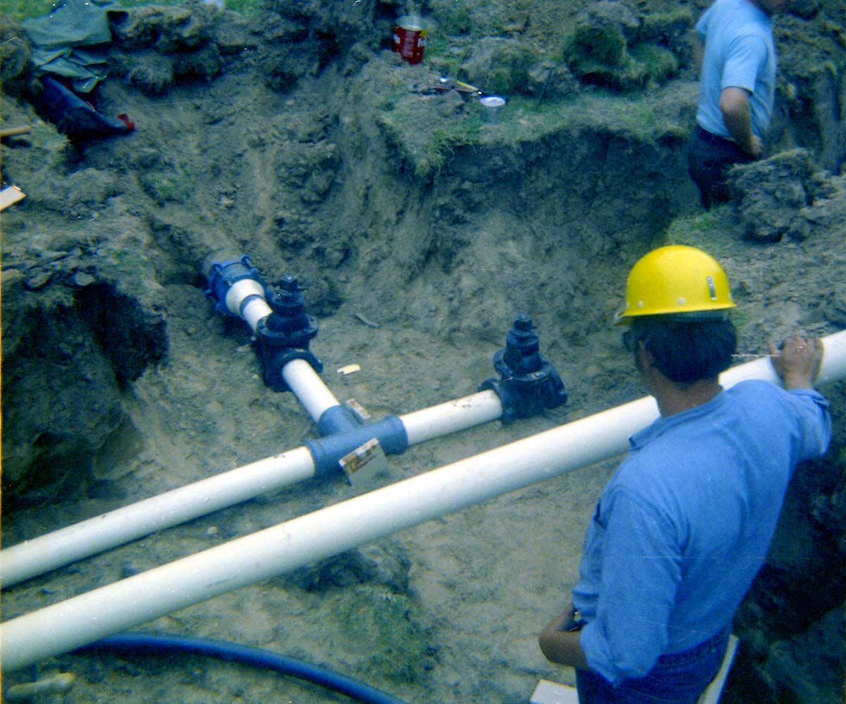 Man inspecting piping system during the Zion Lodge utilities project.