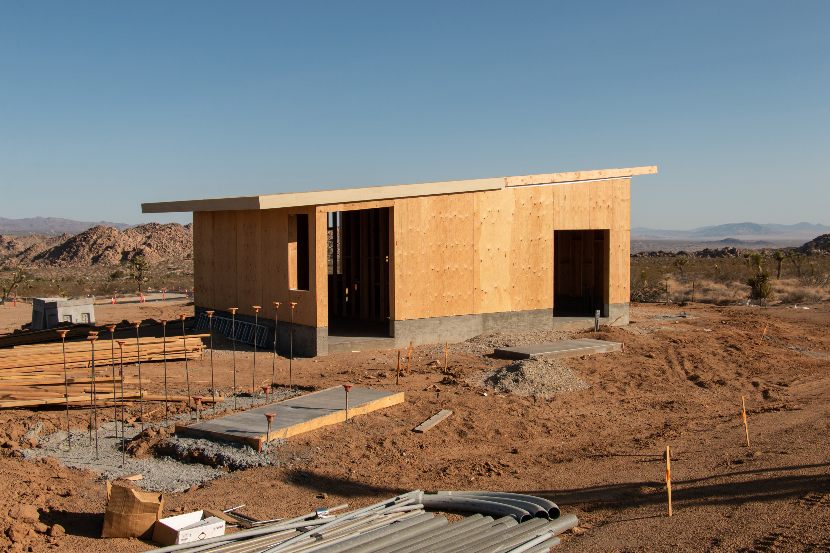 Newly built structure amongst desert backdrop.