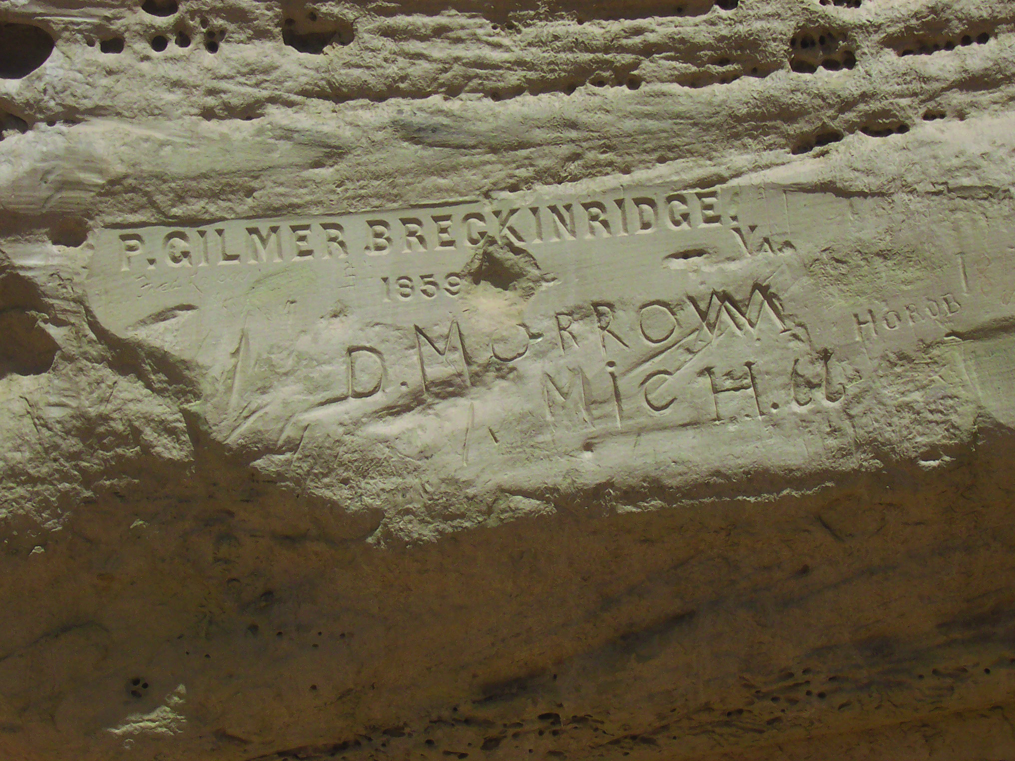 Very  neat block lettering reads P. Gilmer Breckenridge 1859, etched into El Morro's sandstone rock, with other inscriptions around it.