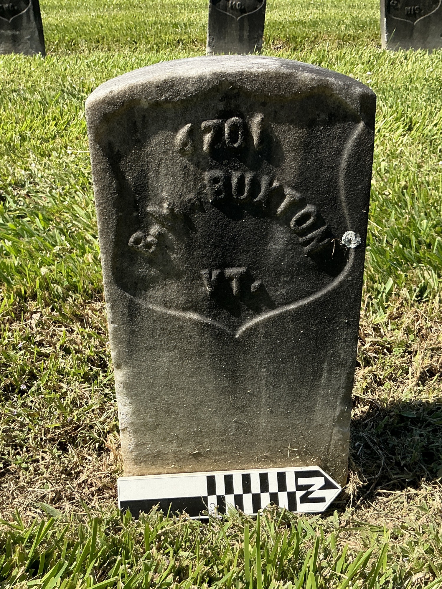 Extra image of historic upright marble headstone with recessed shield face.