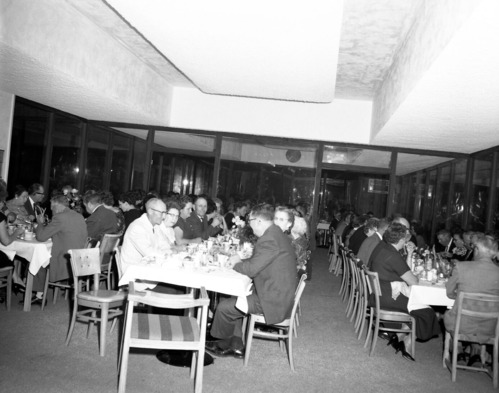 Men and women eating dinner at retirement party for Superintendent Paul R. Franke. Party held at the Driftwood Lodge, Springdale, Utah.